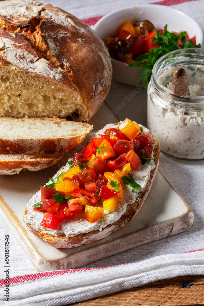 Bruschetta from homemade bread with cottage cheese and sprat pate and tomatoes on a wooden background. Rustic style.