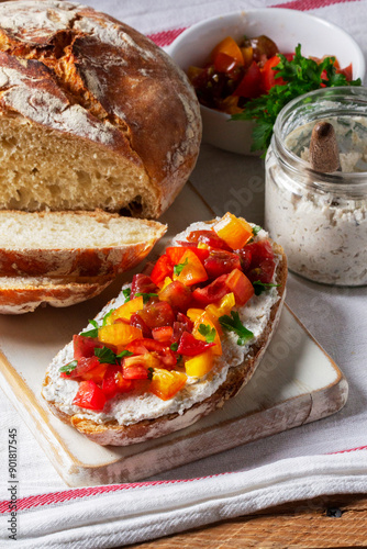 Obraz na płótnie Bruschetta from homemade bread with cottage cheese and sprat pate and tomatoes on a wooden background. Rustic style. w salonie