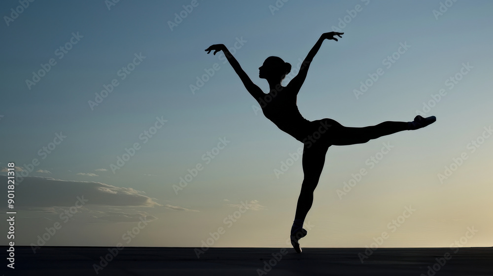 Fototapeta premium Ballet Dancer Performing Arabesque Against Sunset Sky