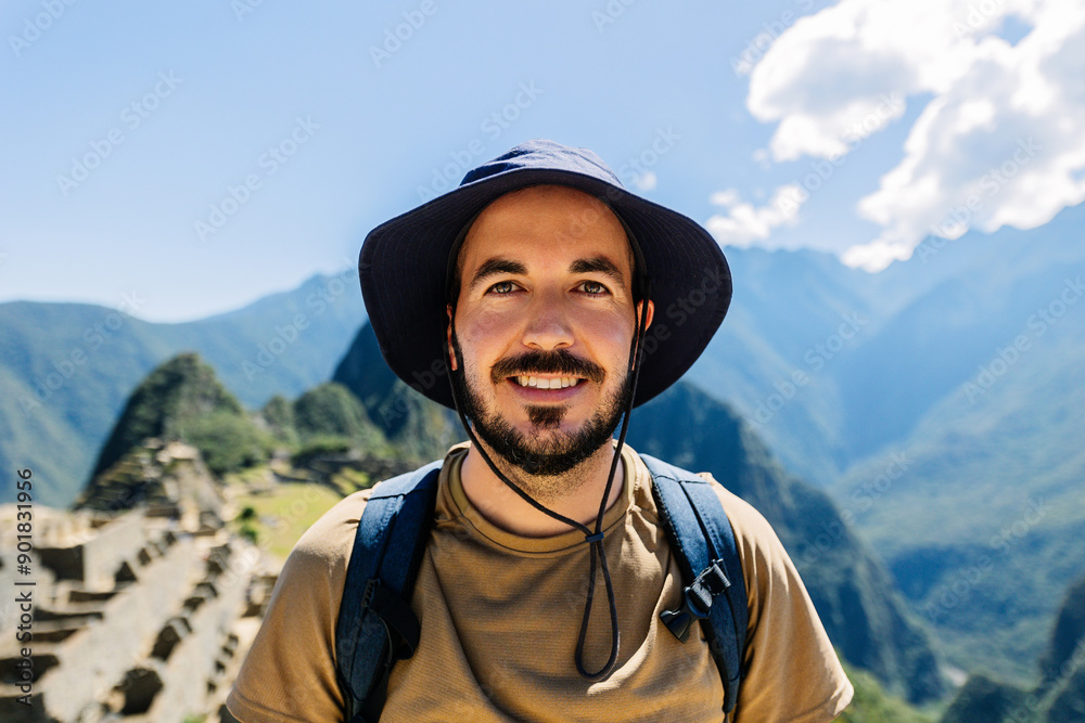Portrait of young happy tourist man in Machu Picchu, Peru Portrait of young happy tourist man in Machu Picchu, Peru