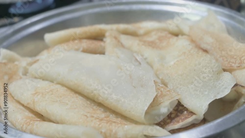 Patishapta Pitha, a famous Bengali Dessert Recipe, being prepared during Winter season. Patishapta is a type of pithe made in celebratory occasions, quick Indian dessert. Howrah, West Bengal, India photo