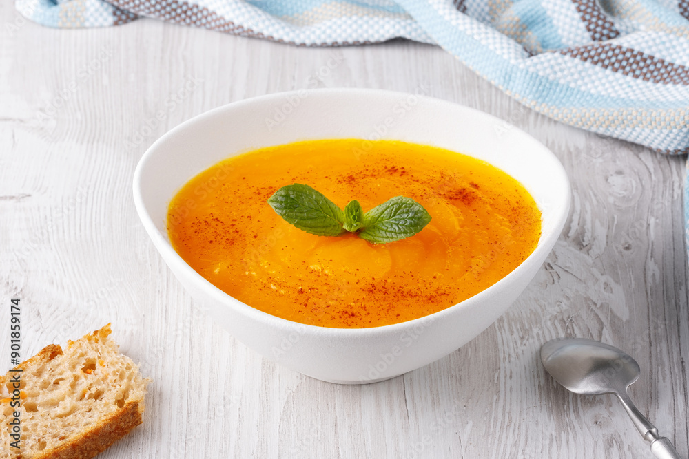 Pumpkin and carrot soup on white background Pumpkin and carrot soup on white background