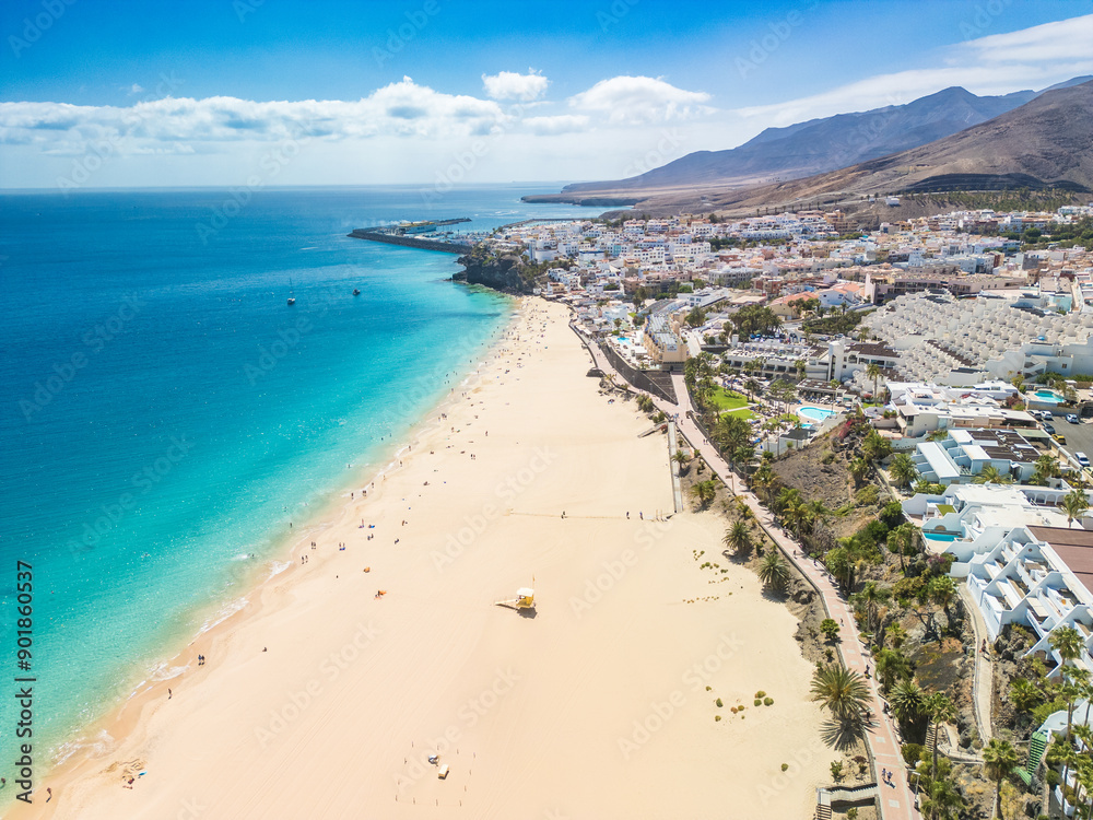 White sandy beach and blue water in Morro Jable, south of Fuerteventura, Canary islands White sandy beach and blue water in Morro Jable, south of Fuerteventura, Canary islands