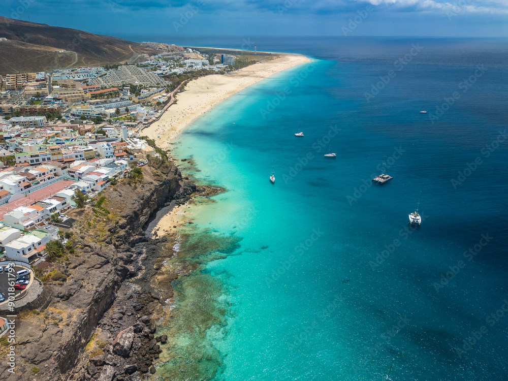 White sandy beach and blue water in Morro Jable, south of Fuerteventura, Canary islands White sandy beach and blue water in Morro Jable, south of Fuerteventura, Canary islands