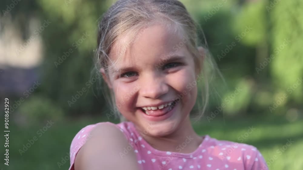 laughing child girl looking at camera summer in the park laughing child girl looking at camera summer in the park