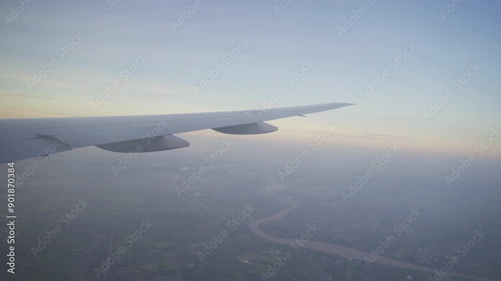 Wing of an airplane jet flying above clouds with blue sky from the window in traveling and transportation concept. Nature landscape background. Wing of an airplane jet flying above clouds with blue sky from the window in traveling and transportation concept. Nature landscape background.
