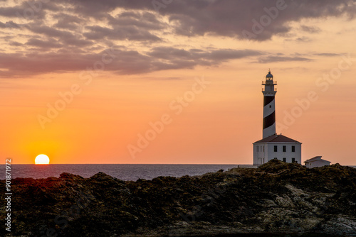 Cape Favaritx lighthouse at sunset, Cap de Favàritx, Menorca, Biosphere Reserve, Balearic Islands, Spain photo