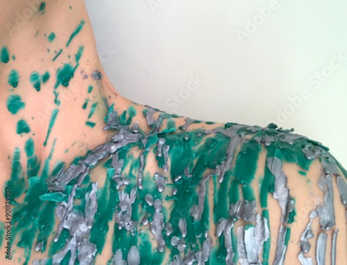 Abstract Body Art with Green and Silver Paint photo