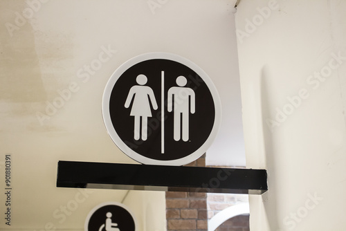 Public restroom signs at the entrance in the meeting room.
