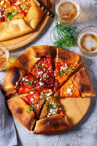 Obraz na płótnie Traditional open pie galette with tomatoes, cheese and herbs, served with beer or wine. w salonie