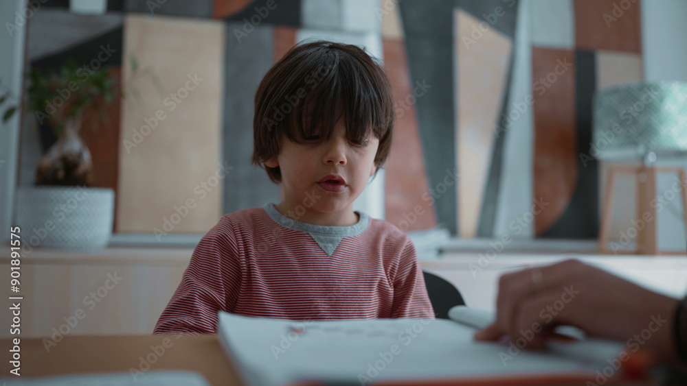 Child reluctant and struggling with learning, showing frustration and difficulty during a learning activity, highlighting the challenges of education in a supportive home environment Child reluctant and struggling with learning, showing frustration and difficulty during a learning activity, highlighting the challenges of education in a supportive home environment