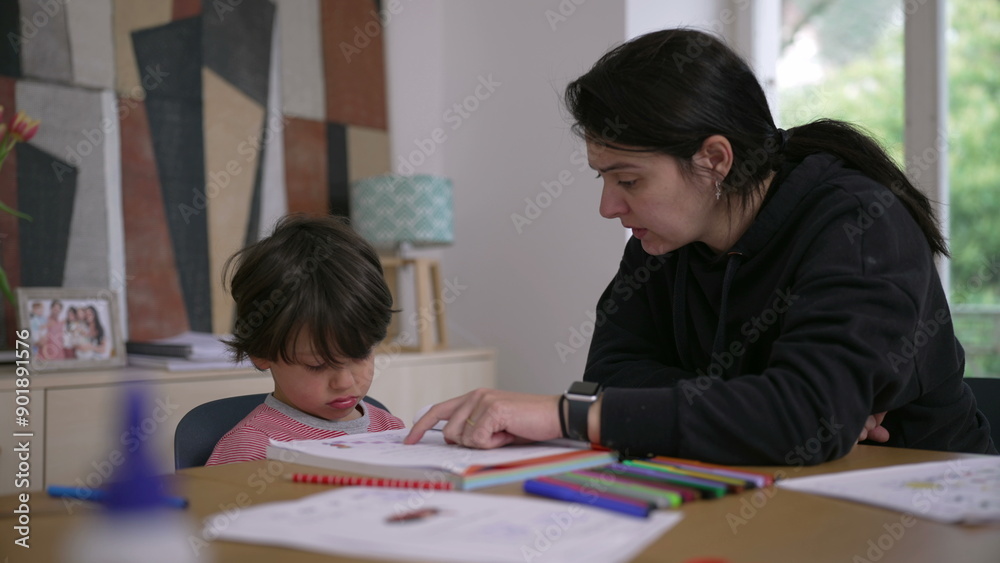 Mother guiding young child who feels reluctant and frustrated with homework, surrounded by educational tools and colorful pencils, demonstrating supportive home learning environment Mother guiding young child who feels reluctant and frustrated with homework, surrounded by educational tools and colorful pencils, demonstrating supportive home learning environment