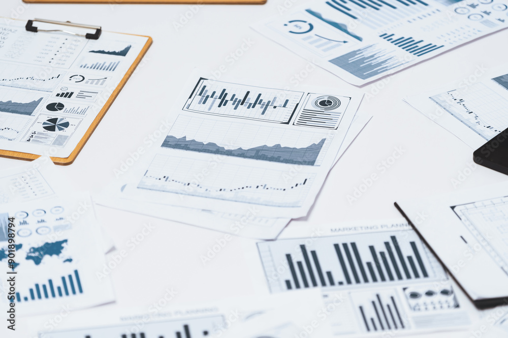 Piles of business intelligence paper or BI financial report and financial data visualization on paperwork for business analytic marketing and strategic planning at office desk. Prudent Piles of business intelligence paper or BI financial report and financial data visualization on paperwork for business analytic marketing and strategic planning at office desk. Prudent