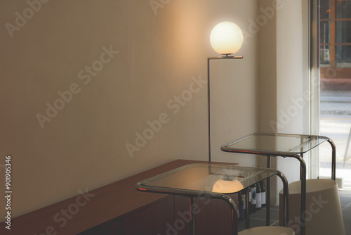 Minimalist and cozy cafe interior with modern lighting and copy space. Small business, food and drink establishment.