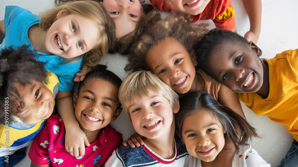 A group of children are smiling and hugging each other in a circle A group of children are smiling and hugging each other in a circle