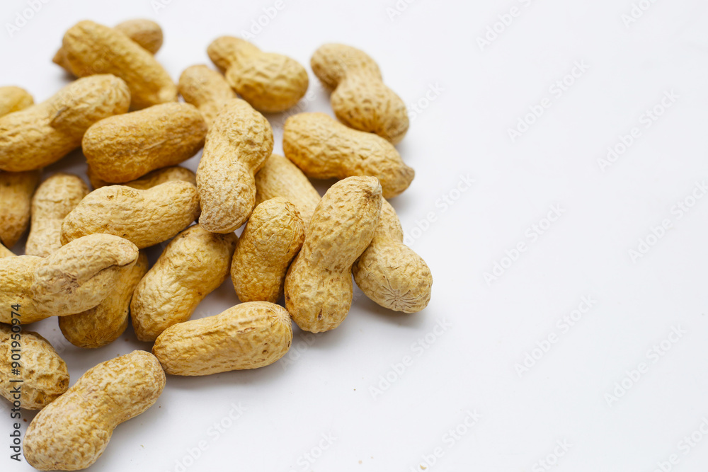 Roasted peanuts in shell on white background. Roasted peanuts in shell on white background.