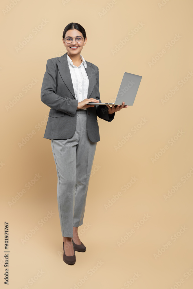 Smiling woman in formal wear using laptop for office work Smiling woman in formal wear using laptop for office work