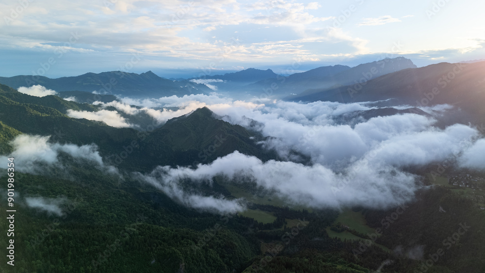 Stunning Aerial View of Mountain Range Surrounded by Clouds During Early Morning Hours Stunning Aerial View of Mountain Range Surrounded by Clouds During Early Morning Hours