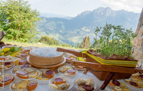 Obraz na płótnie Table with plates of bread, cheese and salami w salonie