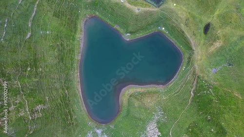 Aerial view of Lake Montagnon in the Pyrénées-Atlantiques, France. Heart-shaped mountain lake at sunrise.