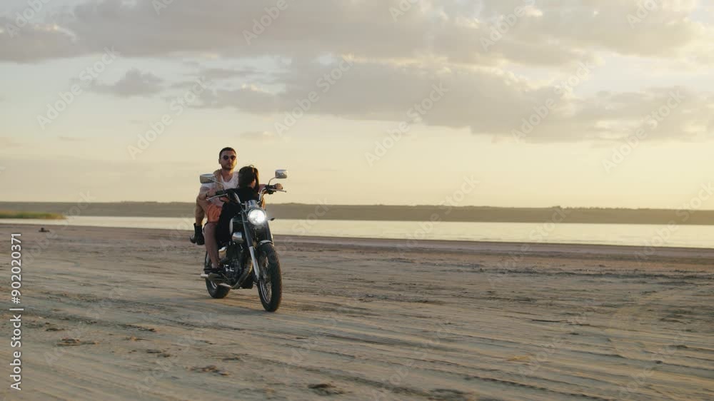 A couple partake in the thrill of a motorcycle ride at the beach at sunset, embracing freedom, adventure, and connection, cherishing joyful moments in the tranquil oceanic landscape A couple partake in the thrill of a motorcycle ride at the beach at sunset, embracing freedom, adventure, and connection, cherishing joyful moments in the tranquil oceanic landscape