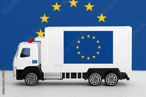 European union flag depicted on side wall of white delivery van close up. Shipping and local delivery concept photo