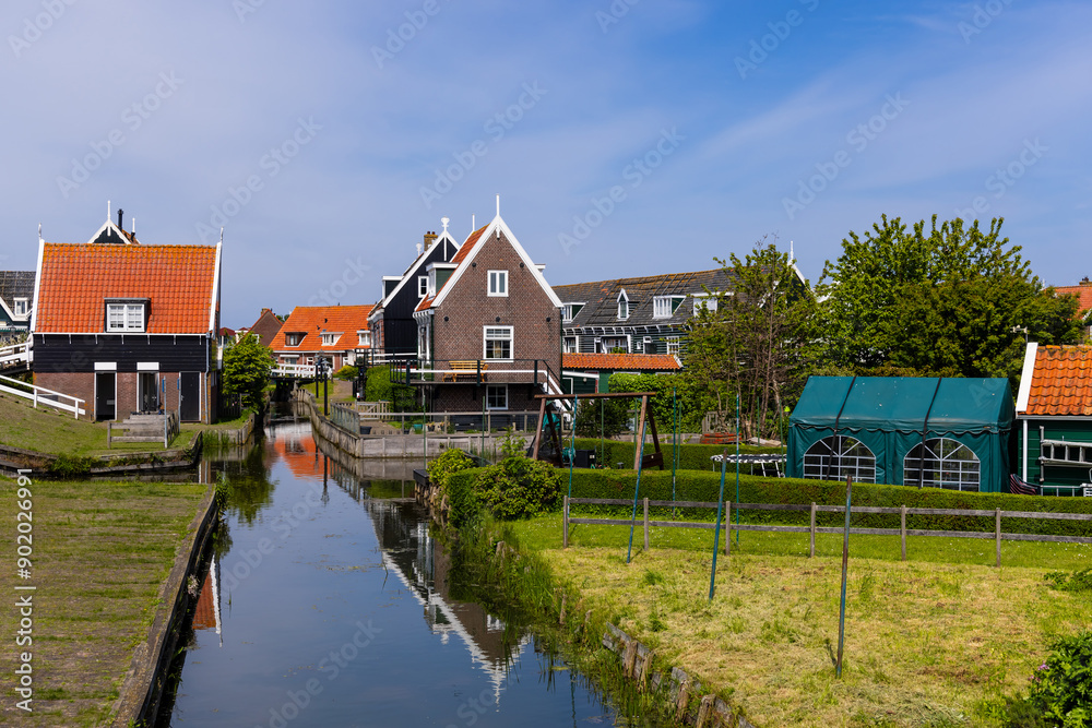 Colorful traditional Dutch style homes on turps and canals in beautiful Marken island, Netherlands. Colorful traditional Dutch style homes on turps and canals in beautiful Marken island, Netherlands.