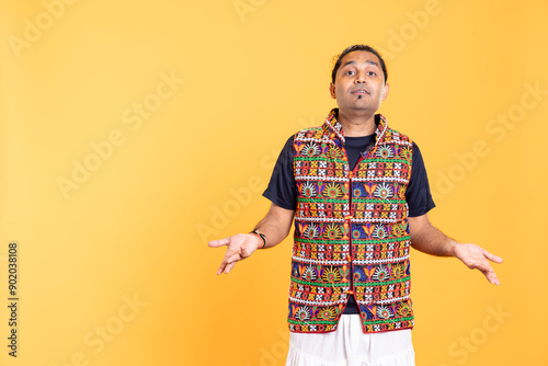 Portrait of perplexed man shrugging shoulders, hesitant to provide answer. Confused person doing questioning hand gesture, showing lack of knowledge, feeling indecisive, studio backdrop