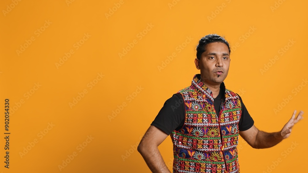 Happy indian person having fun, dancing on rhythm, enjoying leisure time. Cheerful man entertaining himself doing funky movements, isolated over studio background, camera A Happy indian person having fun, dancing on rhythm, enjoying leisure time. Cheerful man entertaining himself doing funky movements, isolated over studio background, camera A