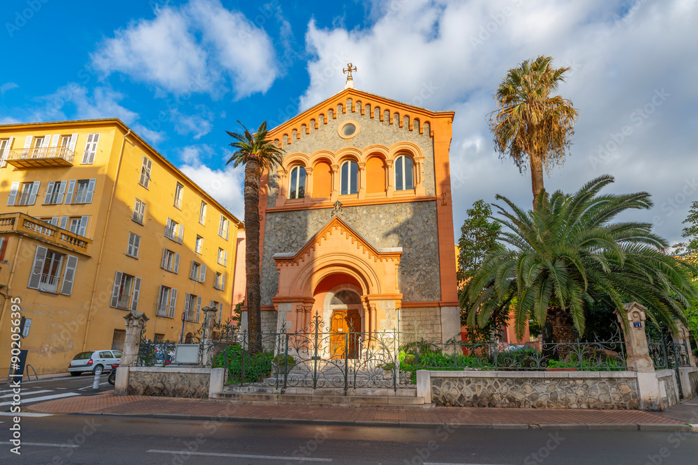 Fototapeta premium The Reformed Protestant Church of France surrounded by palm trees in the Mediterranean city of Menton, France. 