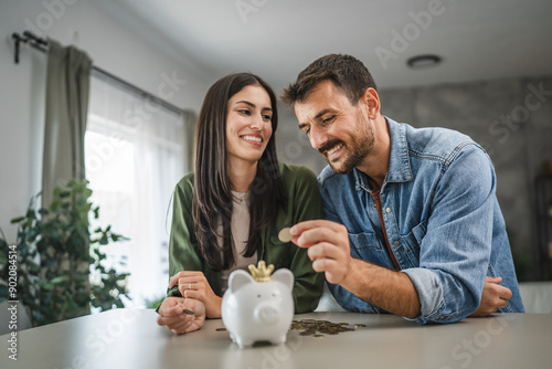 Adult couple save money coins in the piggy bank at home