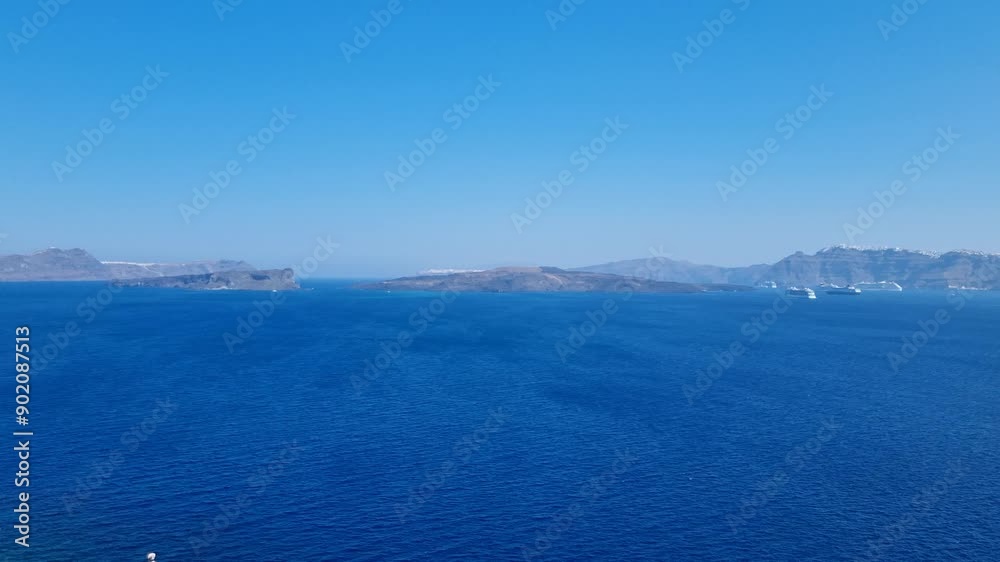 view of cruiseship and island in santorini greece panning right view of cruiseship and island in santorini greece panning right