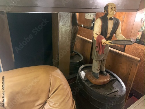 A modern dumb waiter, modelled as a waiter holding out a tray - photo