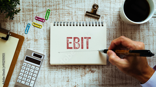 There is notebook with the word EBIT. It is an abbreviation for Earnings Before Interest and Taxes as eye-catching image.