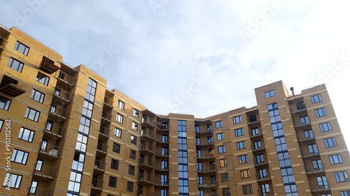 Brick apartment building, under construction. Building house projects. Modern urban apartment house.