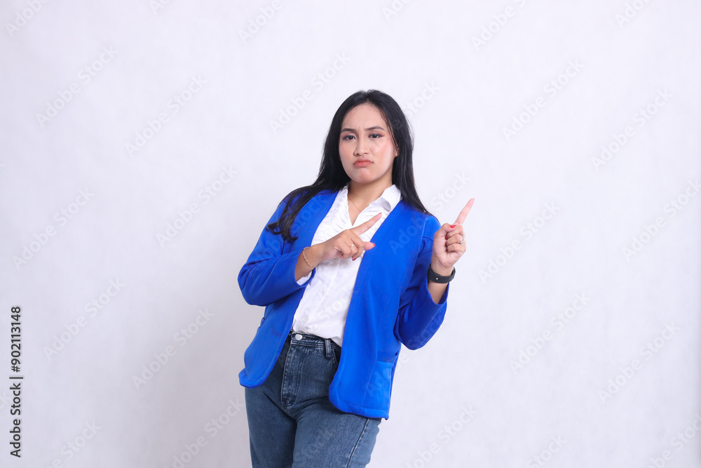 charm of beautiful mature asian office woman wearing blue formal suit standing annoyed both hands pointing left up. for corporate content, beauty, business, finance, promotion charm of beautiful mature asian office woman wearing blue formal suit standing annoyed both hands pointing left up. for corporate content, beauty, business, finance, promotion