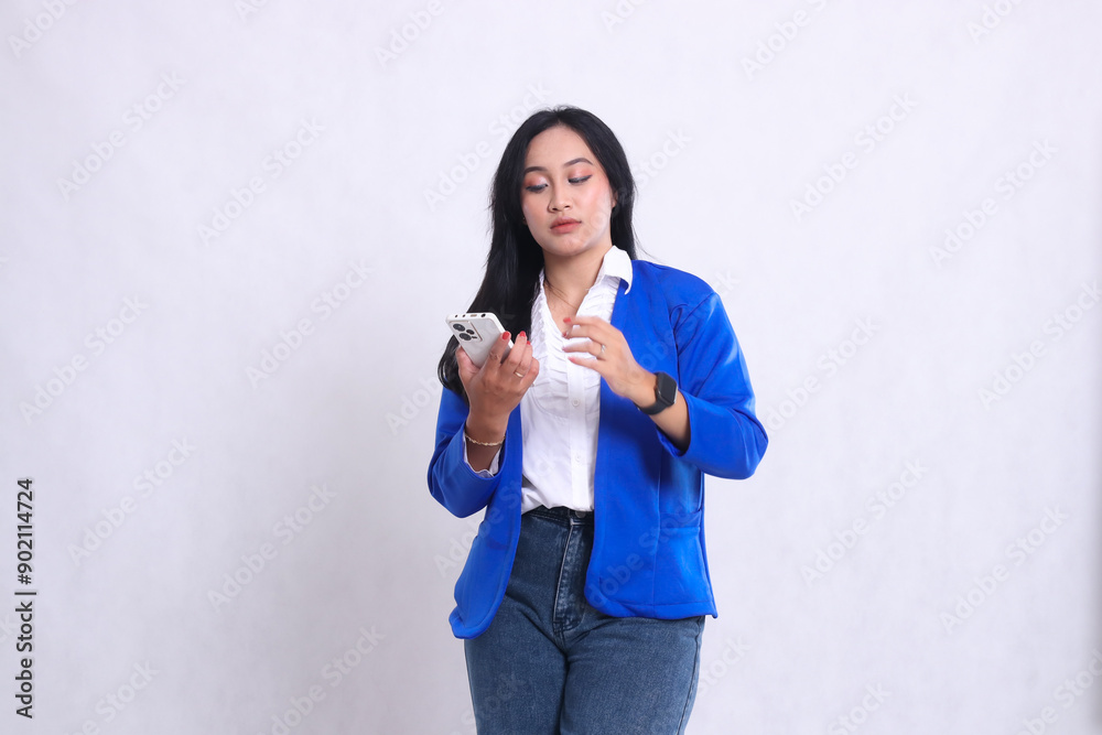 beautiful adult office woman wearing blue formal suit standing elegantly carrying smartphone mobile phone isolated white background. for technology, lifestyle, music, entertainment content beautiful adult office woman wearing blue formal suit standing elegantly carrying smartphone mobile phone isolated white background. for technology, lifestyle, music, entertainment content
