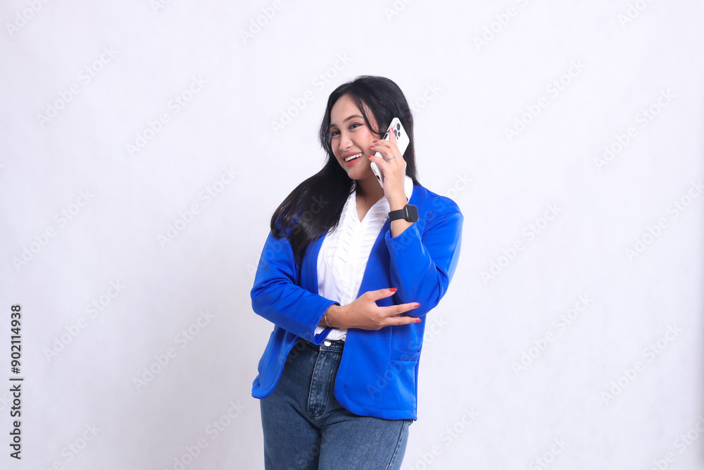 beautiful adult office woman wearing blue formal suit standing smiling cheerful candid while using smartphone cellphone isolated white background. for technology, lifestyle, communication content beautiful adult office woman wearing blue formal suit standing smiling cheerful candid while using smartphone cellphone isolated white background. for technology, lifestyle, communication content
