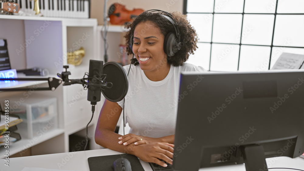 African american woman with headphones in music studio African american woman with headphones in music studio