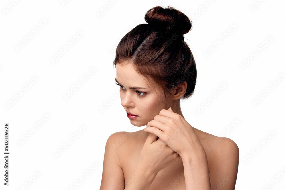 A woman with her hand on her hair looking at the camera, isolated on white background A woman with her hand on her hair looking at the camera, isolated on white background