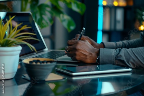 Young casual businessman sitting on the floor using stylus pen and digital tablet working on laptop computer work from home