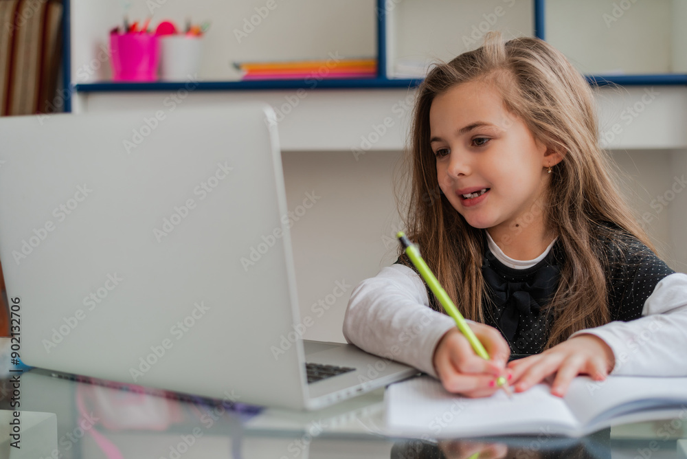 A happy kid student learning for school at the home desk. A happy kid student learning for school at the home desk.