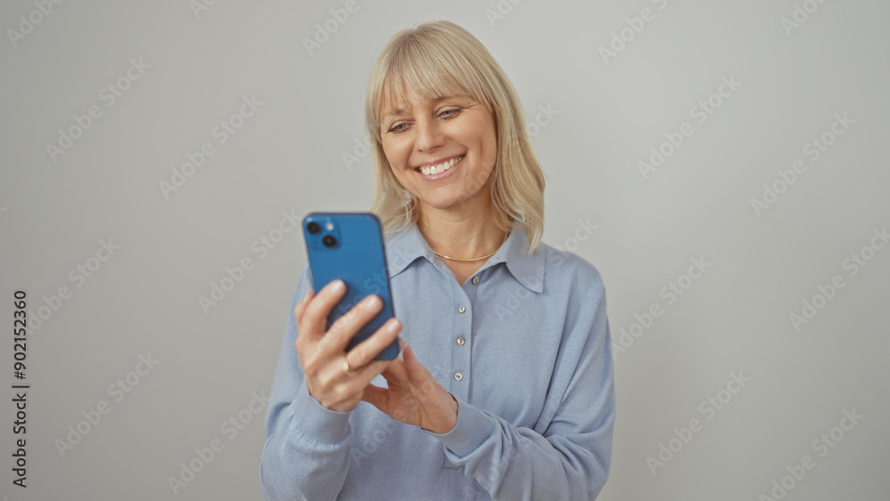 Smiling woman using smartphone against white background Smiling woman using smartphone against white background