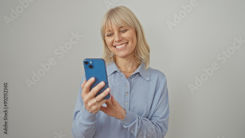 Smiling woman using smartphone against white background