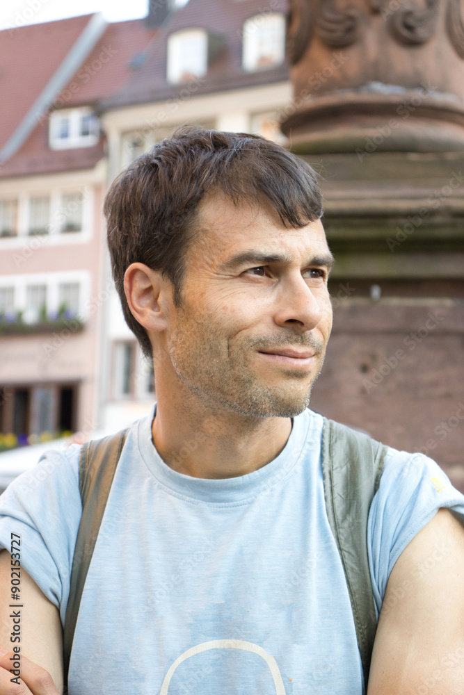 Obraz premium Man Enjoying Sunny Day in Freiburg, Germany Town Square