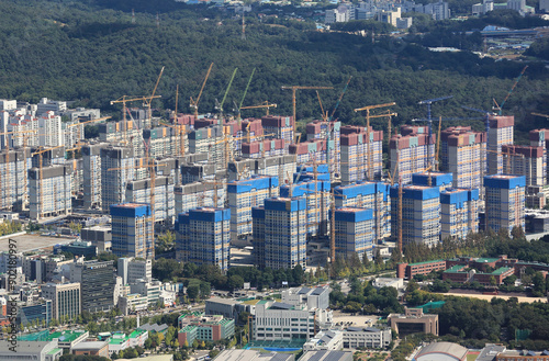 Gangdong-gu, Seoul, South Korea - October 8, 2022: Aerial and summer view of tower cranes on the redevelopment construction site of an apartment 
 photo