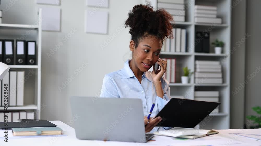 Busy businesswoman managing tasks on phone and laptop in contemporary workspace. Professional businesswoman multitasking on phone and laptop in a modern office, showcasing productivity and skills.