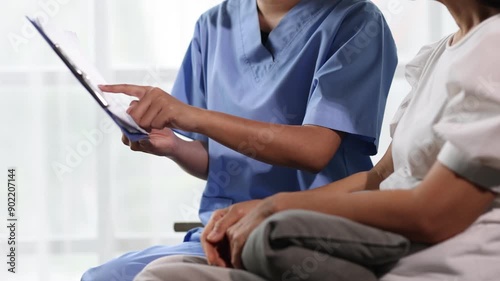 Elderly patient receiving personalized healthcare consultation at home. Healthcare professional discussing with an elderly patient at home, providing personalized care.