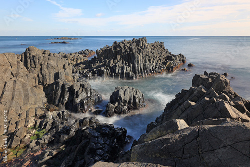 Long exposure of volcanic rocks on the sea against horizon at Gangdong Hwaam Columnar Joint near Buk-gu, Ulsan, South Korea
 photo