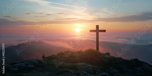 Religious symbol standing on top of a mountain at sunrise